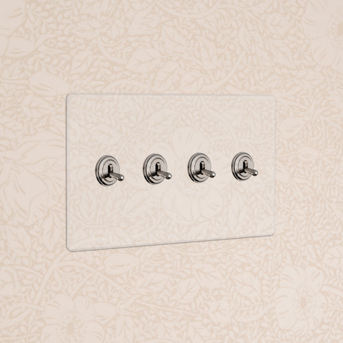 Kew 4G Toggle Switch in clear polished nickel with four switches on a clear rectangular plate.