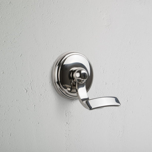 Polished nickel wall-mounted hook with a sleek, modern design, called the Portland Hook.