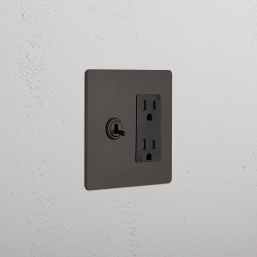 Grove 2G Toggle Switch & Outlet in bronze black with left toggle switch and right double power outlet.