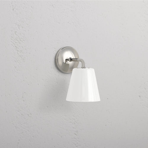 Richmond Medium Wall Light Fine Porcelain in polished nickel with a white conical porcelain lampshade on a wall.