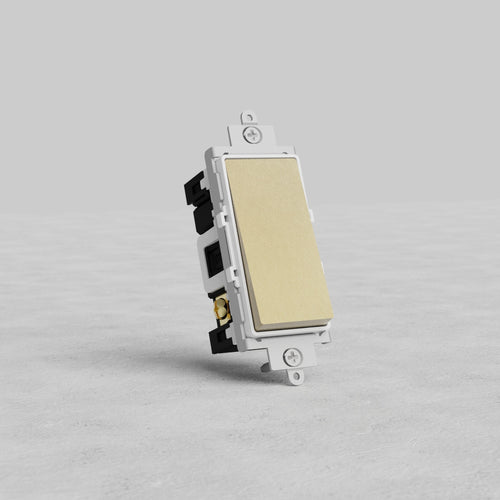 Double Pole Rocker Switch in Antique Brass with white insert, shown upright on a light gray textured surface.