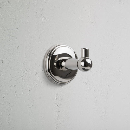 Hyde Hook in polished nickel with a round backplate, featuring a sleek, modern cylindrical design.