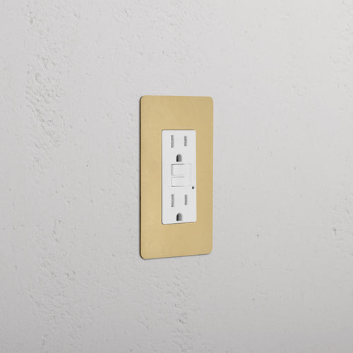 Kew 1G 15A GFCI Outlet in Antique Brass White finish with two sockets and test/reset buttons.