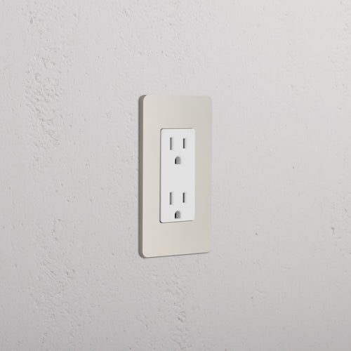Grove 1G 15A outlet in polished nickel white with two sockets, mounted on a light-colored wall.