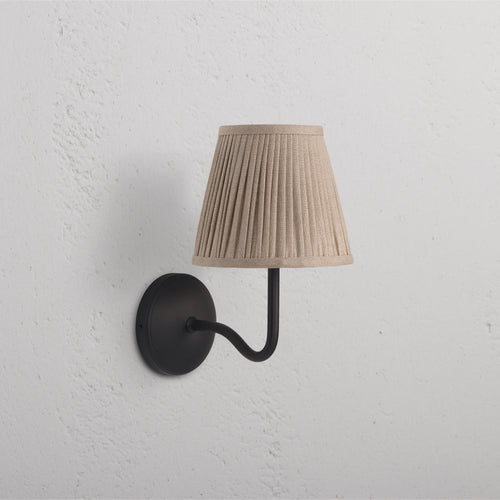 Malvern Medium Wall Light in Natural Beige with bronze arm and base, pleated beige shade mounted on wall.