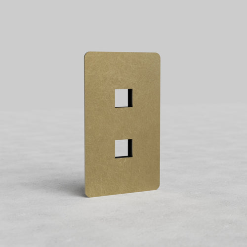Antique Brass 1G 2x Keystone Plate Kew US with two vertical keystone slots, shown on a light gray surface.