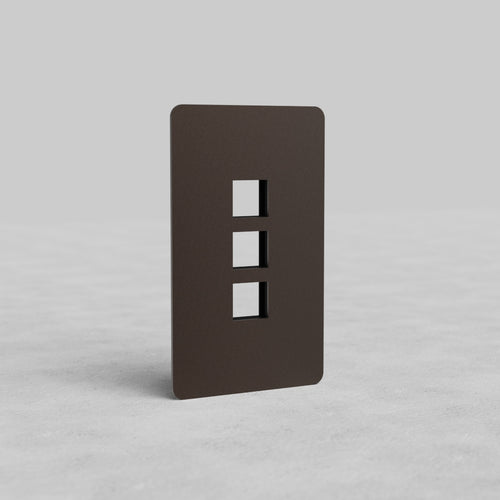 Bronze 1G 3x Keystone Plate Kew US with three rectangular keystone openings on a plain gray background.