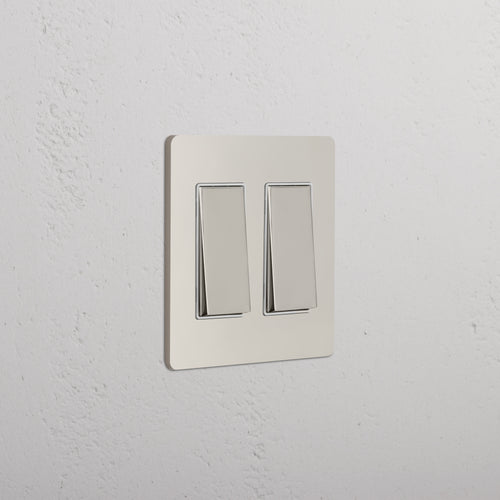 Grove 2G Rocker Switch in Polished Nickel White with two rectangular switches, mounted on a white wall.