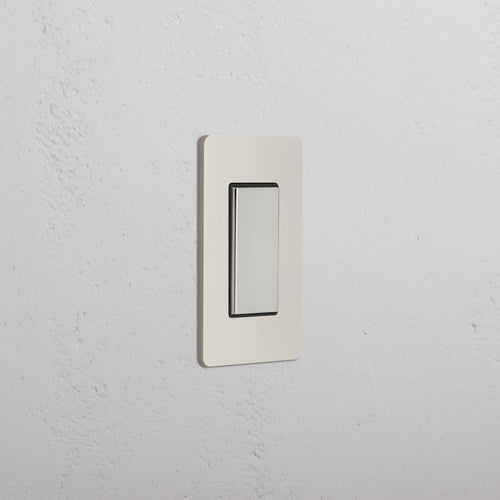 Grove 1G Center Retractive Rocker Switch in polished nickel black finish, mounted on a white textured wall.