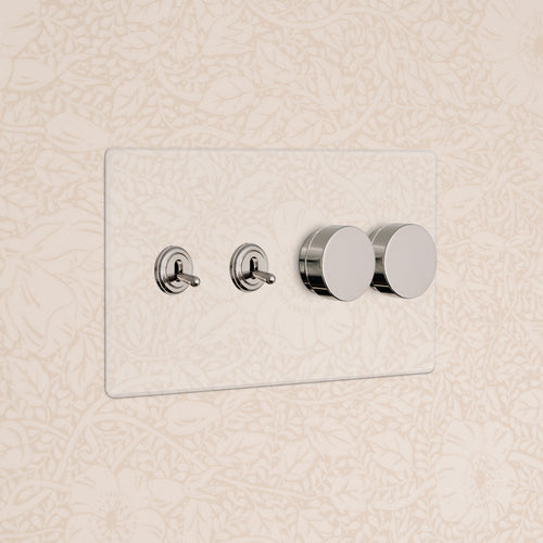 Kew 4G switch panel in clear polished nickel with 2 toggle switches and 2 dimmer dials on a wall.