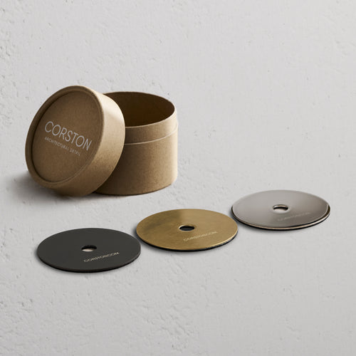 Sample Finish Set box with lid off, showing four labeled metal finish discs and a matching fixture piece.