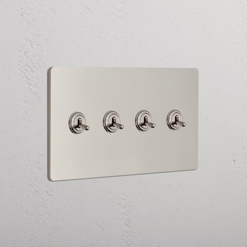 Grove 4G Toggle Switch in polished nickel with four horizontally aligned toggles on a metallic wall plate.