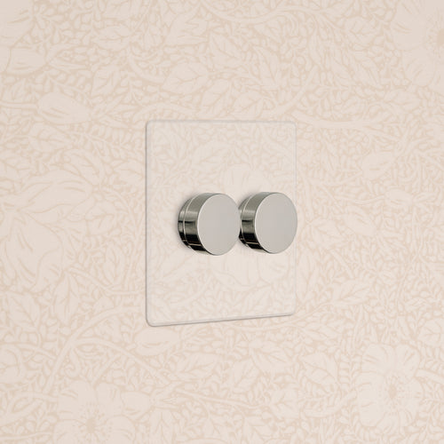 Kew 2G Dimmer Switch in Clear Polished Nickel with two round dials on a clear rectangular plate.