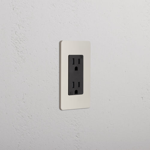 Grove 1G 15A Outlet in polished nickel black finish with two vertical plug slots on a white faceplate.