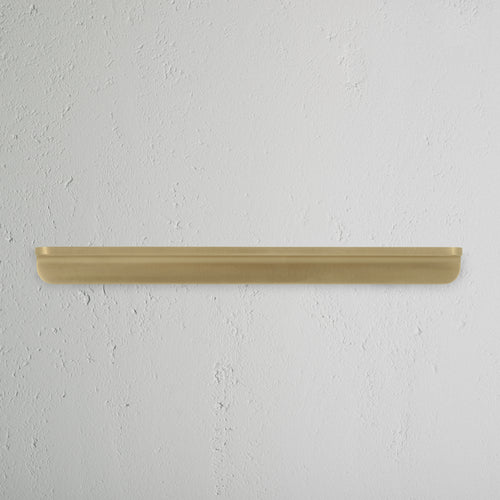 Antique brass Oxford Furniture Handle Medium, mounted on a white surface, shown in close-up view.