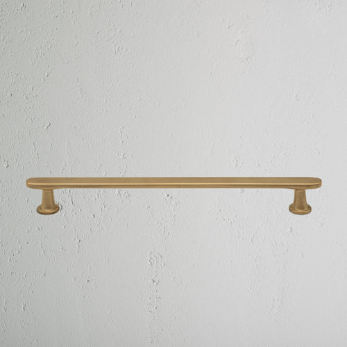 Milliner Furniture Handle Medium in antique brass, featuring a horizontal bar with round bases.
