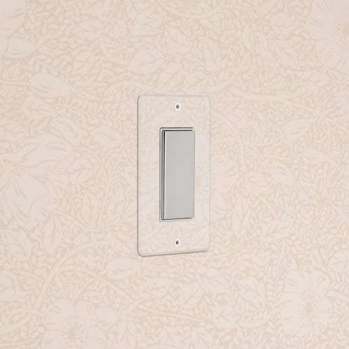 Kew 1G Center Retractive Rocker Switch in clear polished nickel white with a clear rectangular faceplate on wall.