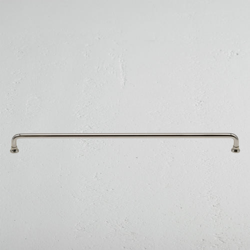 Large Sycamore furniture handle in polished nickel finish, mounted horizontally on a light wall.