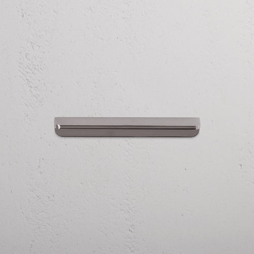 Oxford Furniture Handle Small in polished nickel, a sleek metallic handle with rounded ends on a white surface.