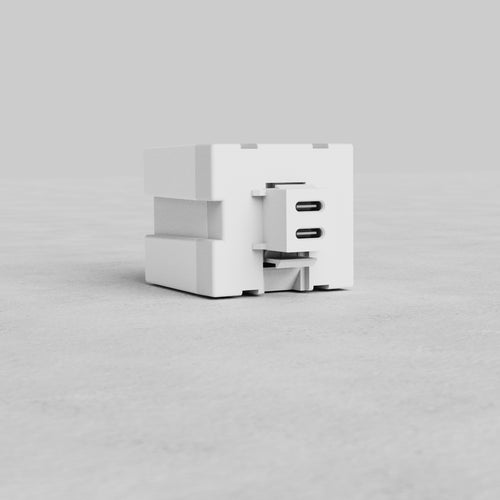White 65W Fast Charge Keystone Module with dual USB-C ports, shown on a light grey surface.