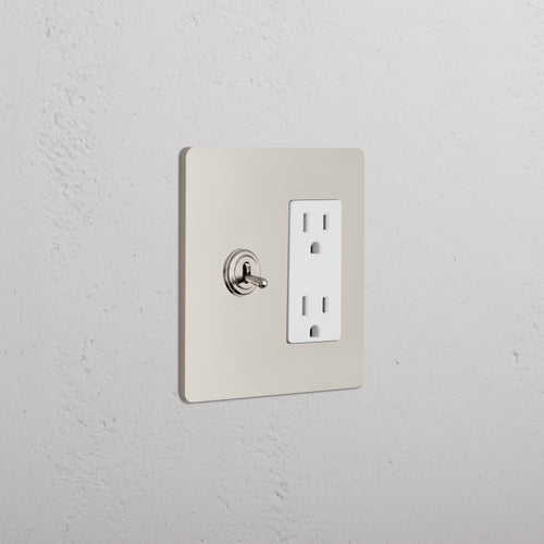 Grove 2G Toggle Switch & Outlet in Polished Nickel White mounted on a wall, showing both switch and outlet.