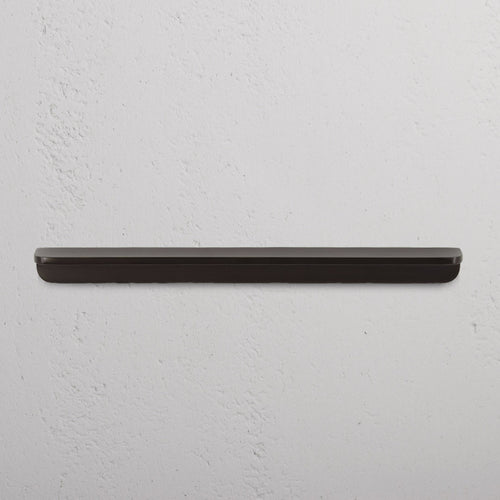 Bronze Oxford Furniture Handle Medium mounted on a white surface, showing its modern, sleek design.