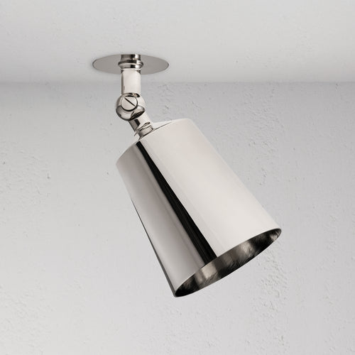 Perryn Single 70mm Spotlight in polished nickel with angled cylindrical shade, mounted on a white ceiling.