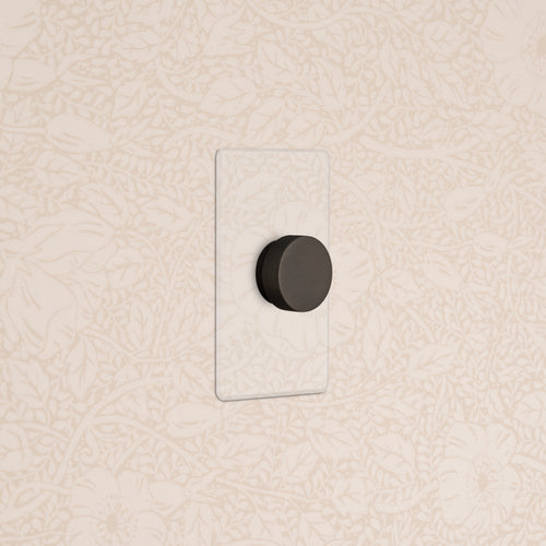 Kew 1G Dimmer Switch in clear bronze finish, mounted on a wall.