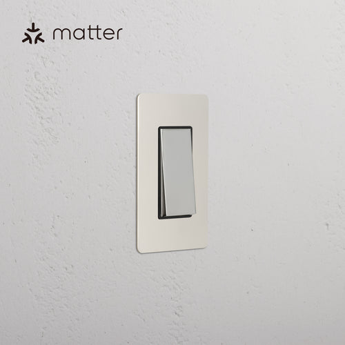 Kew 1G Smart Retractive Rocker Switch in polished nickel black, shown on a white wall with Matter logo.